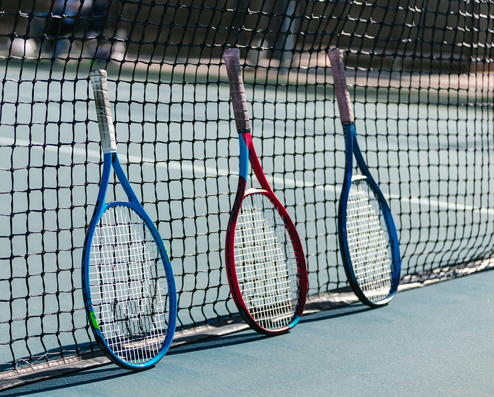 three tennis rackets and net